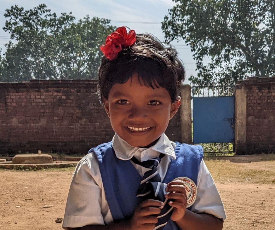 Child in school uniform in India encoruring donations to Christmas Gifts Appeal