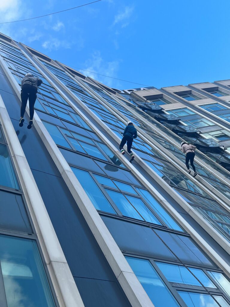 Year 13 students abseiling down the side of the Europa hotel, Belfast